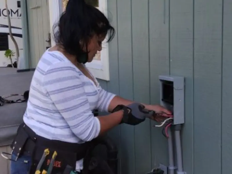 Licensed electrician wiring an exterior subpanel in Prosper